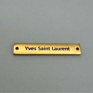 High-quality gold-tone metal tag with “Yves Saint Laurent” engraving.